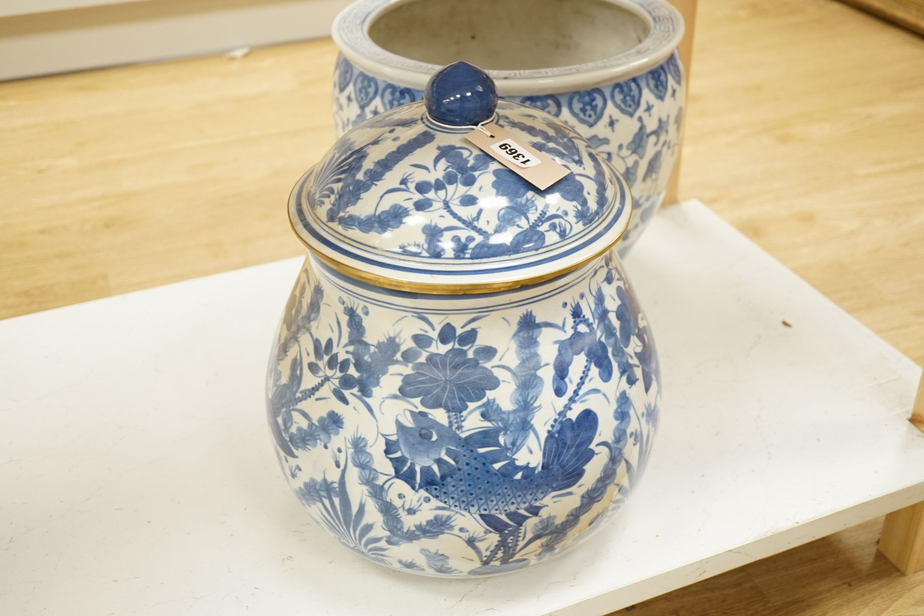 A Chinese blue and white fish bowl and a similar jar and cover, fish bowl 20 cms diameter.